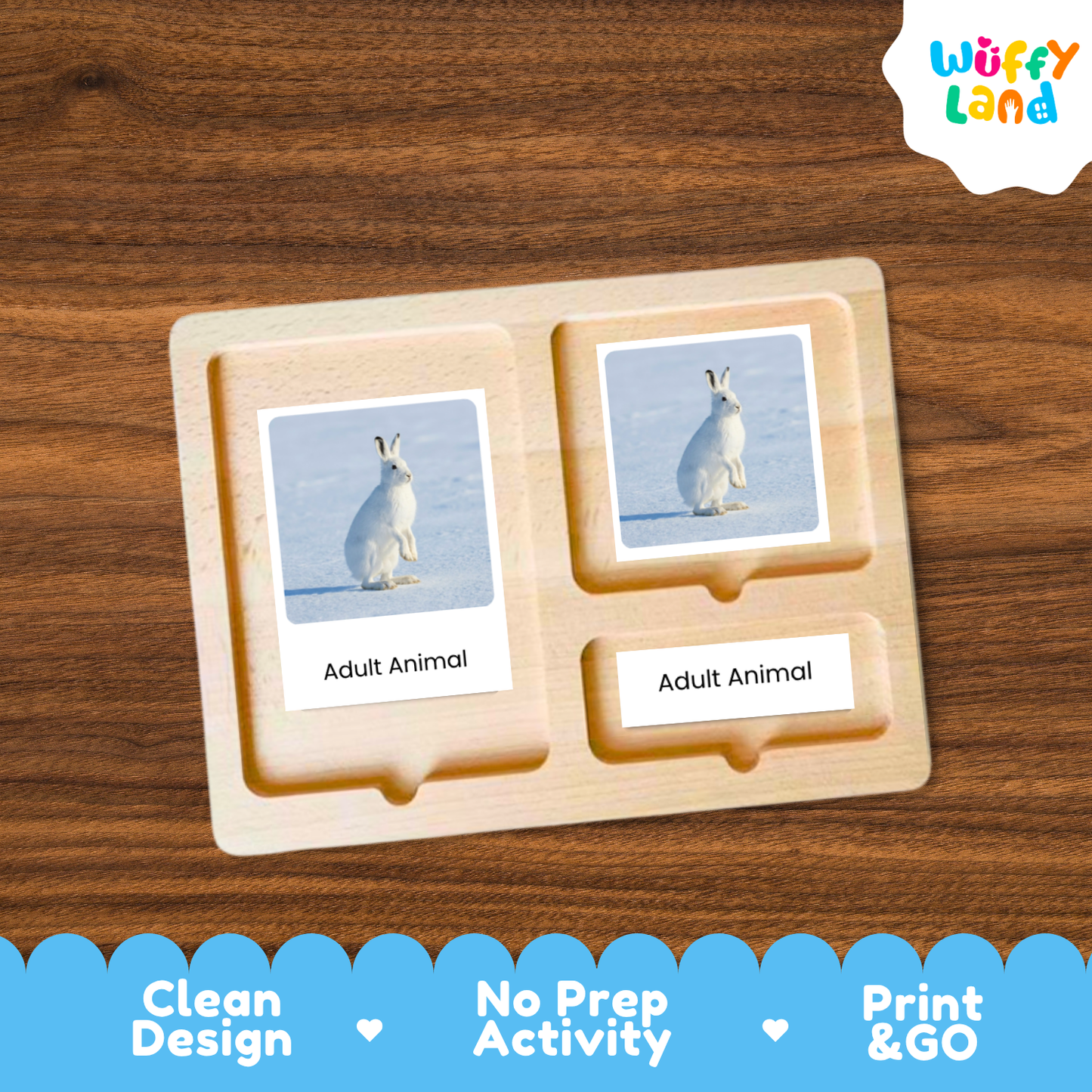 A wooden Montessori-style activity tray labeled 'Adult Animal' with two photo cards showing a white rabbit in a snowy landscape, placed on a brown wood surface. The 'Wuffy Land' logo appears in the top right, and a blue banner at the bottom highlights 'Clean Design', 'No Prep Activity', and 'Print & GO'.