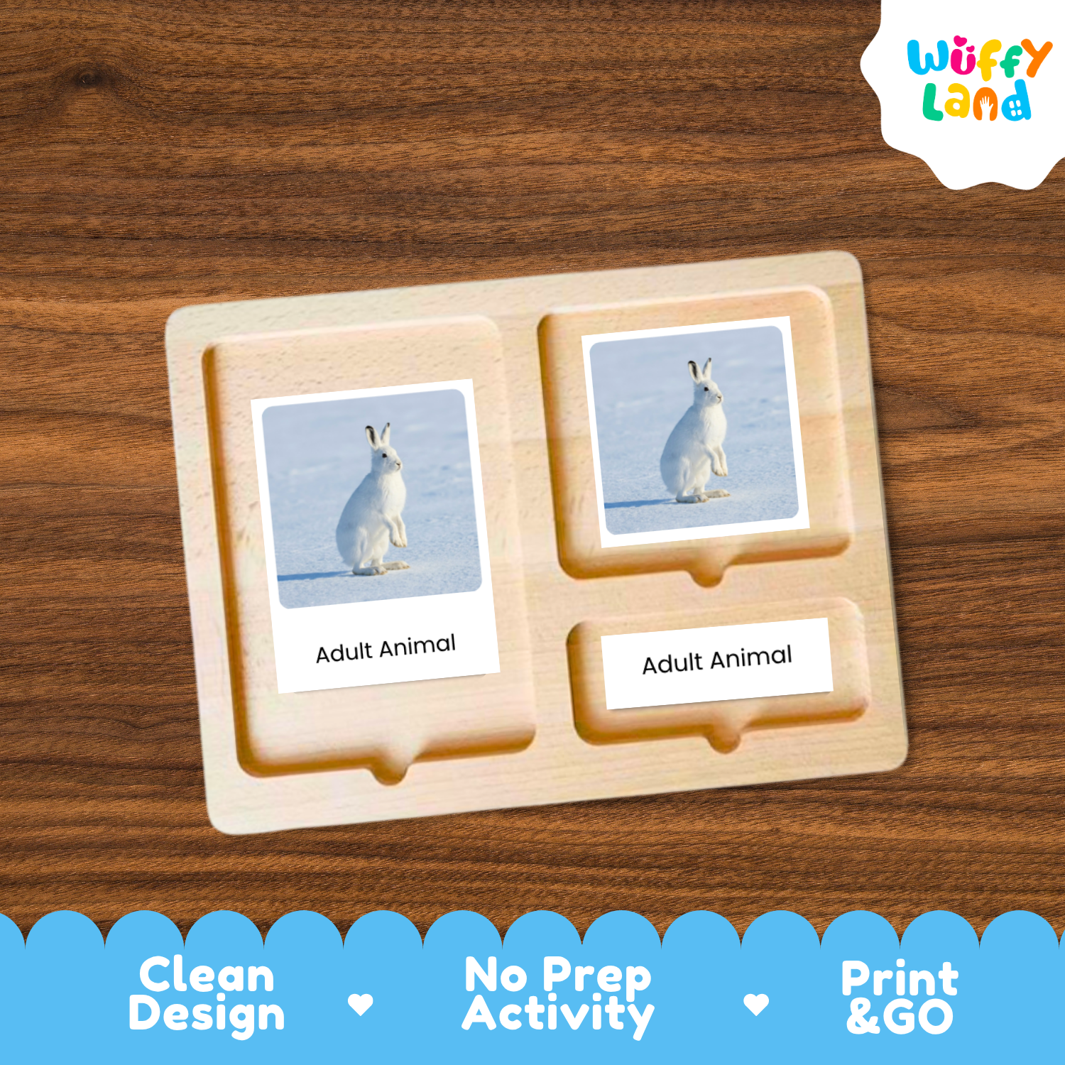 A wooden Montessori-style activity tray labeled 'Adult Animal' with two photo cards showing a white rabbit in a snowy landscape, placed on a brown wood surface. The 'Wuffy Land' logo appears in the top right, and a blue banner at the bottom highlights 'Clean Design', 'No Prep Activity', and 'Print & GO'.