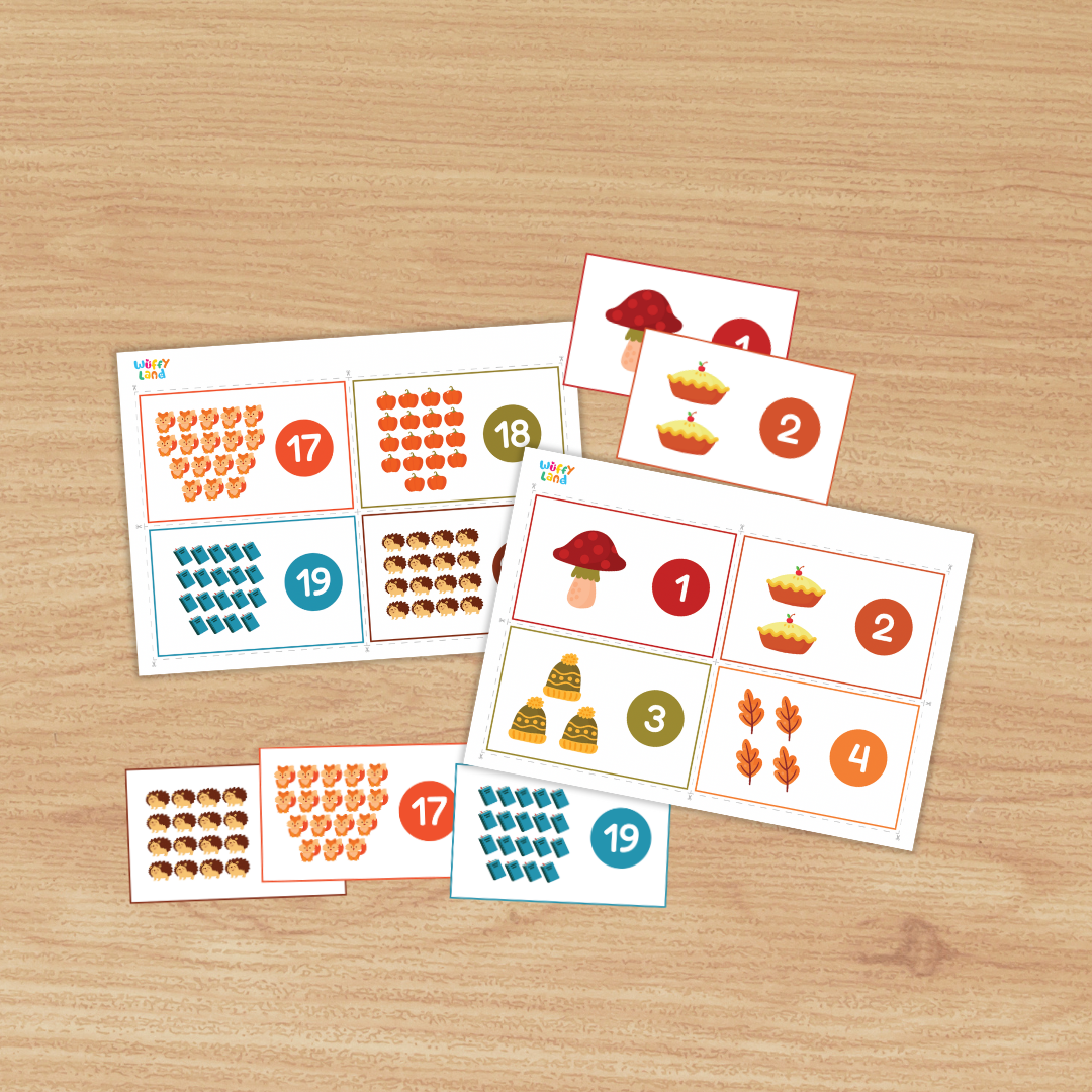 Set of printable counting cards on a wood background featuring autumn icons—mushroom, apple pies, leaves, trees, hedgehogs, foxes, and books. Each card shows a group of items with a large numeral in a colored circle (e.g., 1, 2, 8, 9, 17, 19), designed to practice counting numbers 1–20.