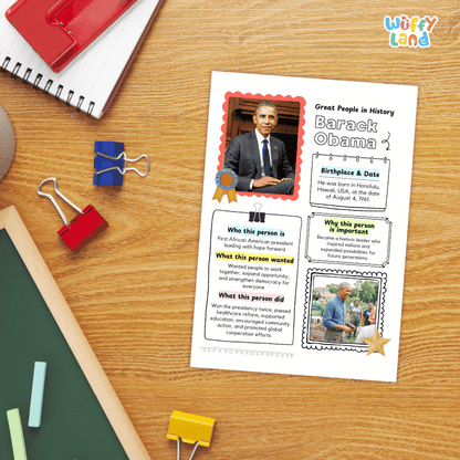 A printed educational worksheet about Barack Obama displayed on a wooden desk, surrounded by school supplies including a spiral notebook, binder clips, chalk, and a red notebook.