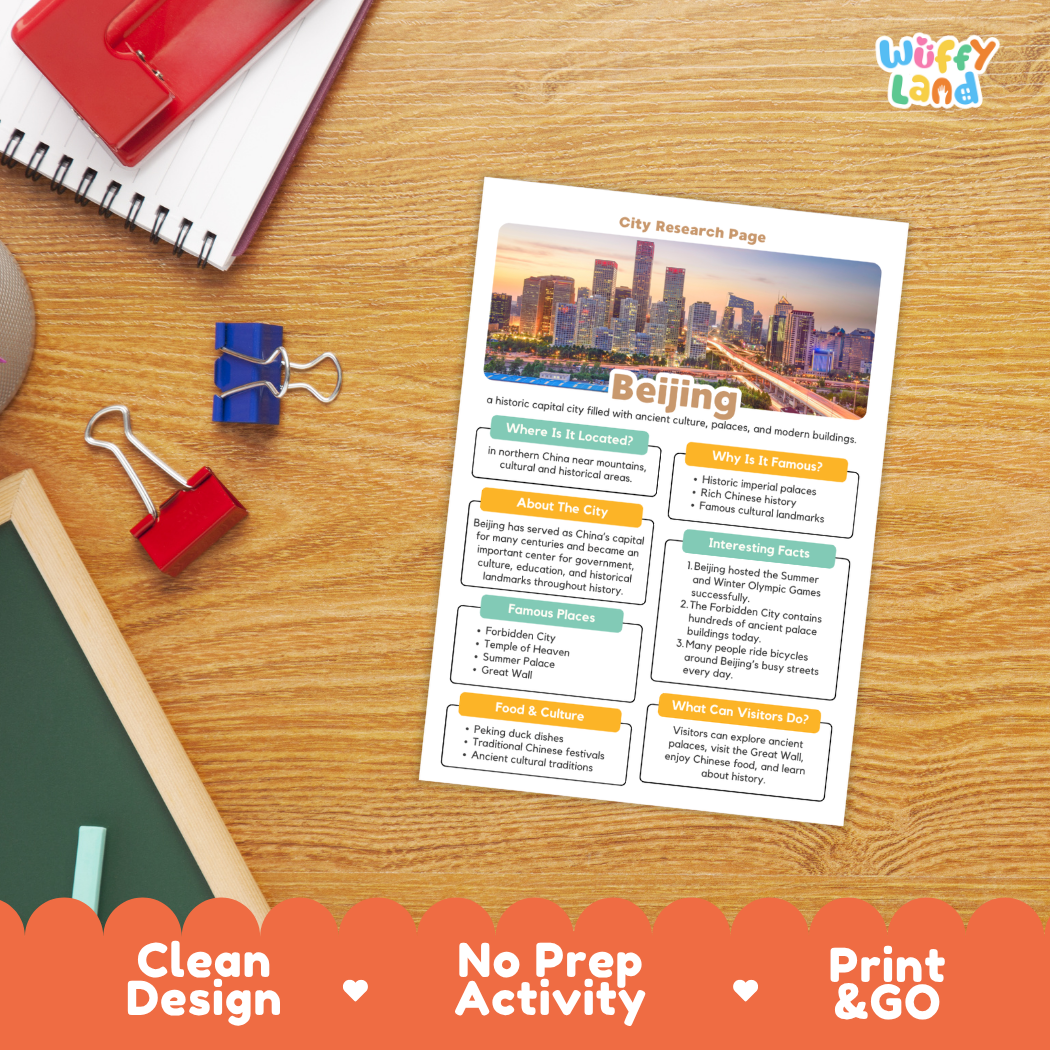 A printed city research page about Beijing is shown on a wooden desk with school supplies around it. The page has a colorful city skyline header and sections for location, why it is famous, about the city, interesting facts, food and culture, and what visitors do.