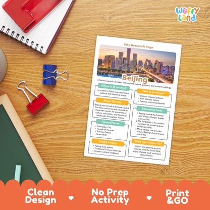 A printed city research page about Beijing is shown on a wooden desk with school supplies around it. The page has a colorful city skyline header and sections for location, why it is famous, about the city, interesting facts, food and culture, and what visitors do.