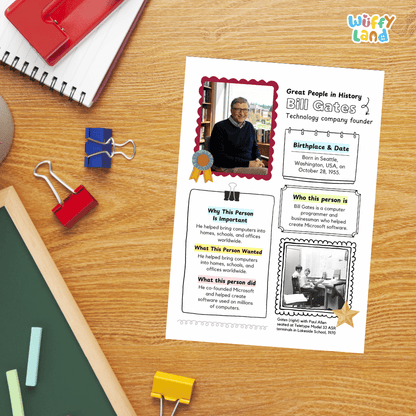 A printed educational worksheet about Bill Gates is laid on a wooden desk with school supplies around it, including a red notebook, blue and red binder clips, chalk, and a green board. The worksheet has colorful text boxes, a photo of Bill Gates, and decorative borders.