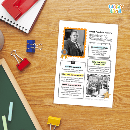 A printed educational worksheet about Booker T. Washington laid on a wooden desk, surrounded by school supplies including a spiral notebook, binder clips, chalk, and a green board.