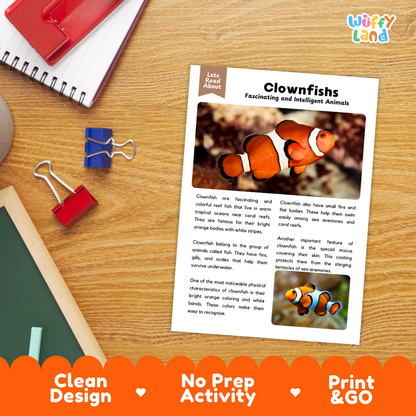 An educational reading activity sheet about clownfishes, displayed on a wooden desk with binder clips and notebooks. The sheet features text and two photos of orange and white clownfish.