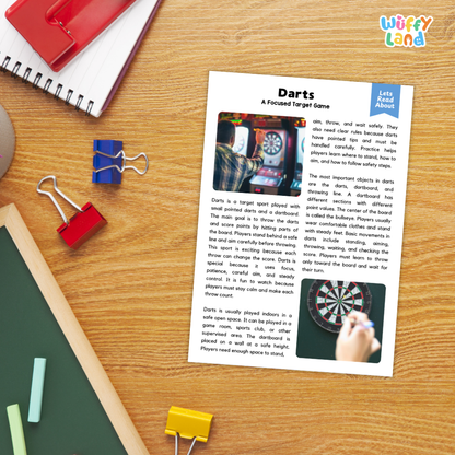 A printed educational worksheet about the game Darts, laid flat on a wooden desk with a red spiral notebook, blue binder clips, and a green folder nearby.