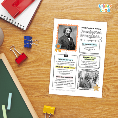 A children's educational worksheet about Frederick Douglass lies on a wooden desk, surrounded by school supplies including a spiral notebook, binder clips, chalk, and a green board. The worksheet features a portrait of Frederick Douglass and text boxes about his life and contributions.