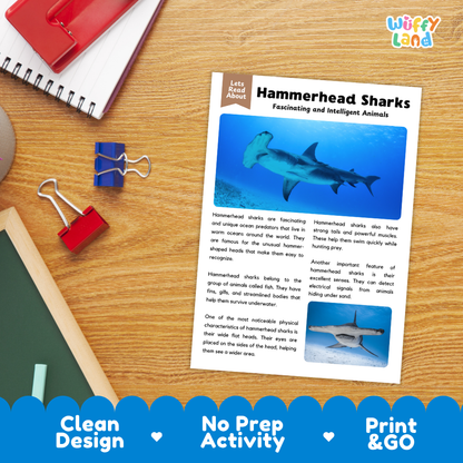 An educational reading activity sheet about hammerhead sharks, displayed on a wooden desk with binder clips and a red notebook. The sheet features a blue header and text with illustrations of hammerhead sharks.
