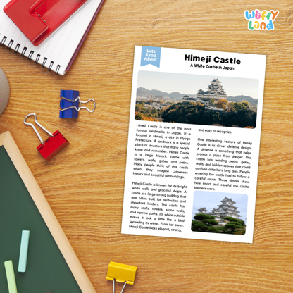A printed educational worksheet about Himeji Castle laid on a wooden desk, surrounded by school supplies including a spiral notebook, red notebook cover, green folder, and binder clips.