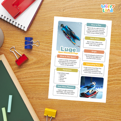 A printed educational poster about the Luge Sport research page, displayed on a wooden desk with colorful school supplies including binder clips, a red notebook, and a green chalkboard.