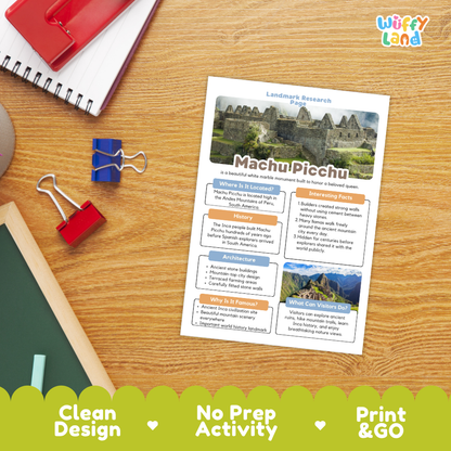 An educational 'Landmark Research Cards' activity sheet about Machu Picchu displayed on a wooden desk with school supplies. The sheet features a white background with colorful text boxes and historical images of the ancient ruins.