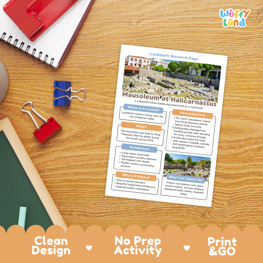 An educational activity sheet titled 'Mausoleum at Halicarnassus' laid out on a wooden desk with school supplies like a spiral notebook, binder clips, and a chalkboard. The sheet is branded with 'Wiffy Land' in the top right corner.