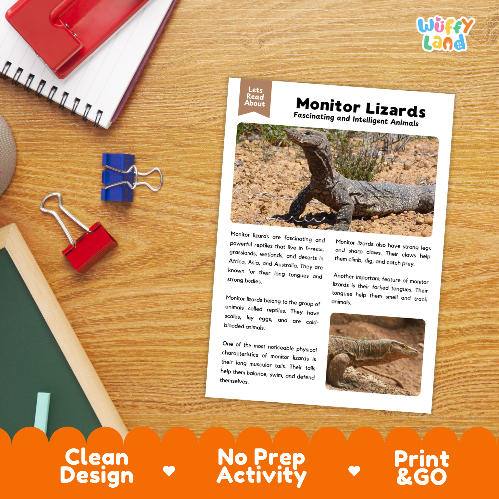 An educational activity sheet titled 'Monitor Lizards' laid flat on a wooden desk, surrounded by school supplies like a red notebook, blue binder clips, and a pen. The sheet includes text and photos of monitor lizards.
