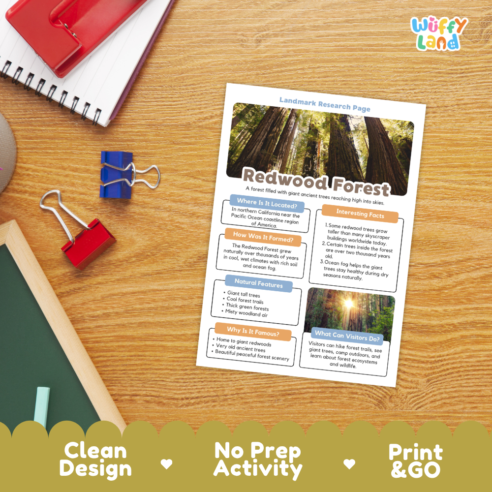 A printed redwood forest landmark research page laid on a wooden desk, surrounded by school supplies including a spiral notebook, binder clips, chalk, and a red folder. The page has a clean design with a redwood forest photo, text sections, and a colorful header.
