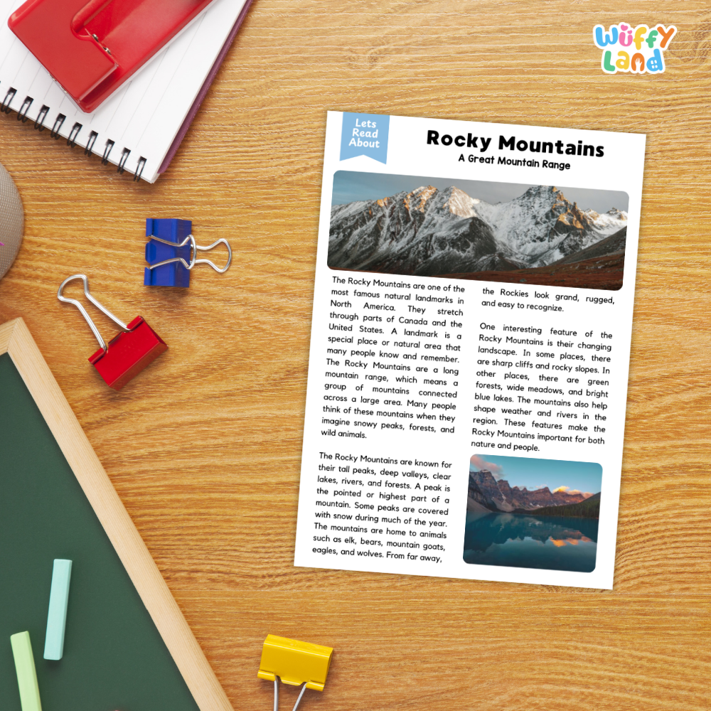 A children's educational worksheet titled 'Rocky Mountains: A Great Mountain Range' by Let's Learn About, displayed on a wooden desk next to a red notebook, blue and red binder clips, and other school supplies.