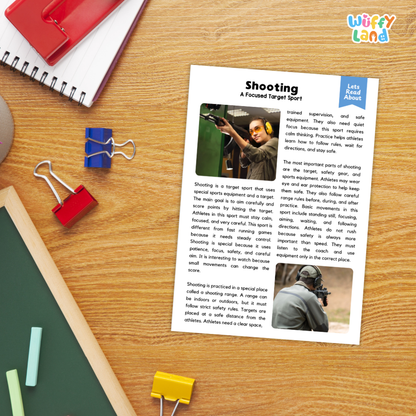 A printed educational worksheet titled 'Shooting: A Focused Target Sport' with text, two small photos, and a blue 'Let's Read About' label, placed on a wooden desk with a spiral notebook, red binder clips, green and yellow paper clips, and a blue 'Wiffly Land' logo in the corner.