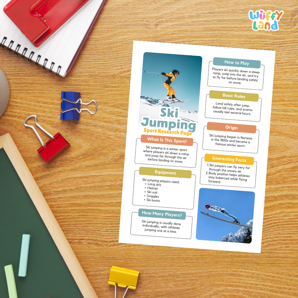 A printed educational poster titled 'Ski Jumping Sport Research Page' by Wiffy Land, displayed on a wooden desk with colorful school supplies including a red spiral notebook, binder clips, chalk, and a green board.