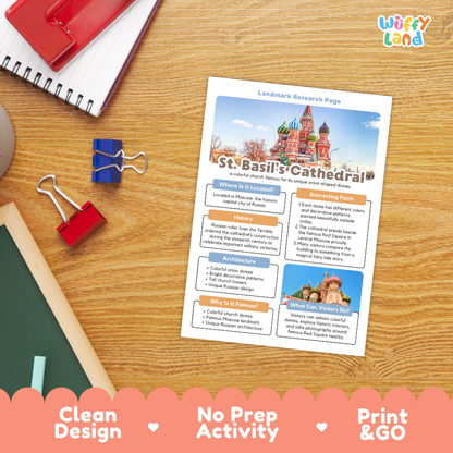 A printed St. Basil's Cathedral landmark research page laid on a wooden desk, surrounded by school supplies including a spiral notebook, a red notebook, binder clips, and a chalkboard.