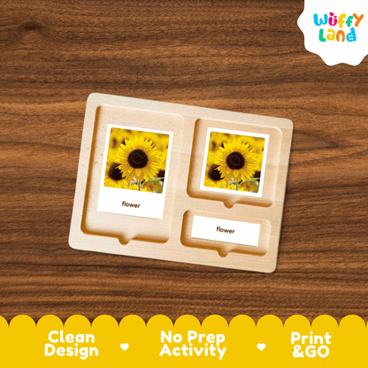 A wooden Montessori-style activity tray with three compartments, each holding a small printed card showing a yellow flower and the word 'flower,' placed on a brown wood-grain surface. A 'Wuffy Land' logo appears in the top right, and a yellow banner at the bottom reads 'Clean Design,' 'No Prep Activity,' and 'Print & GO.