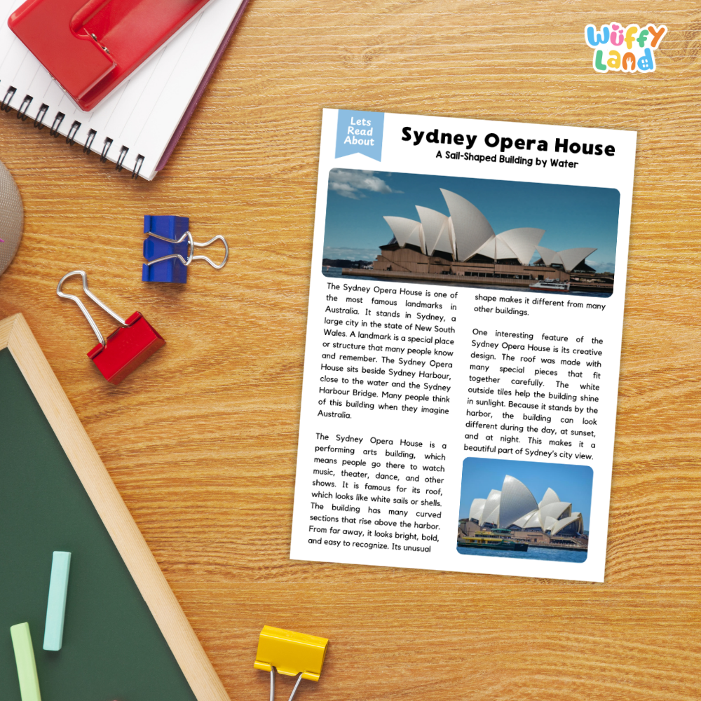 An educational worksheet titled 'Sydney Opera House' printed on a white card, styled on a wooden desk with school supplies including a spiral notebook, a red notebook, blue and red binder clips, and a green folder.