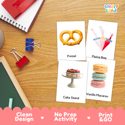 Four printed activity cards showing a pretzel, piping bag, cake stand, and vanilla macaron, arranged on a wooden desk with school supplies. The cards are labeled 'Pretzel,' 'Piping Bag,' 'Cake Stand,' and 'Vanilla Macaron,' and the brand 'Wiffly Land' appears in the top right.