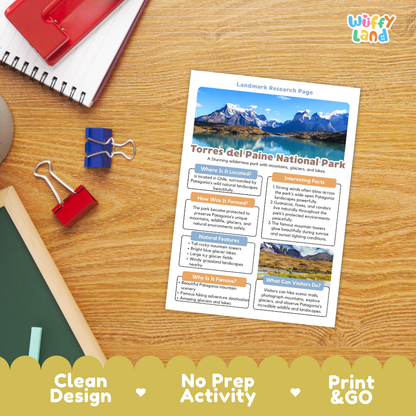 A printed activity sheet titled 'Landmark Research Page' for Torres del Paine National Park, laid on a wooden desk with a spiral notebook, binder clips, chalk, and a red folder nearby. The sheet includes a mountain landscape photo and text sections.